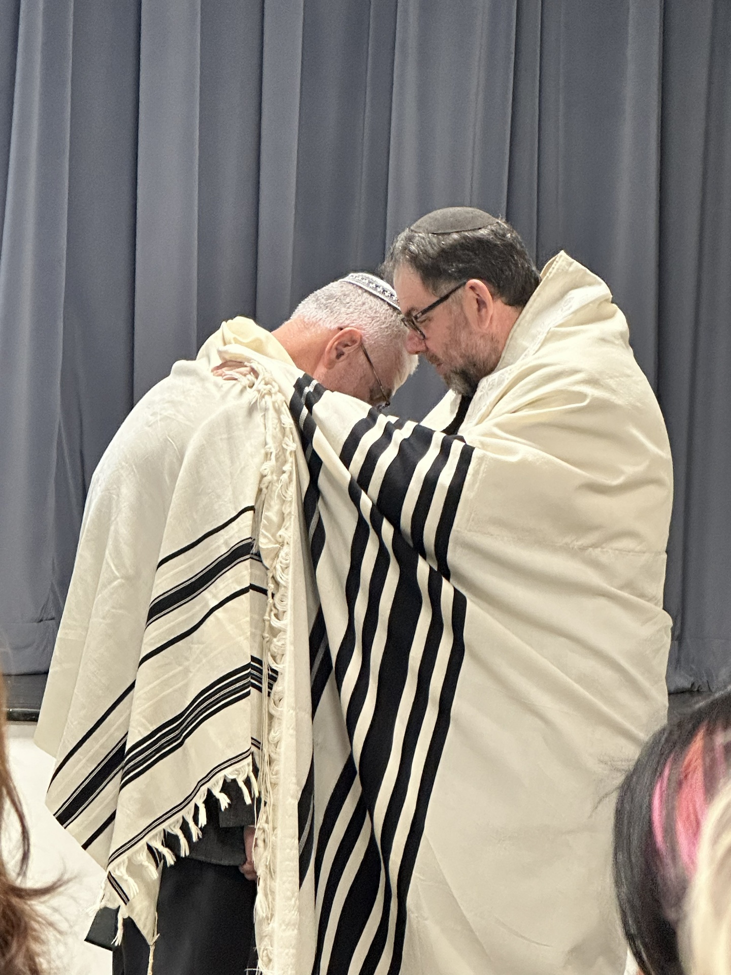 Rabbi Donald Meltzer receiving ordination, wrapped in a tallit